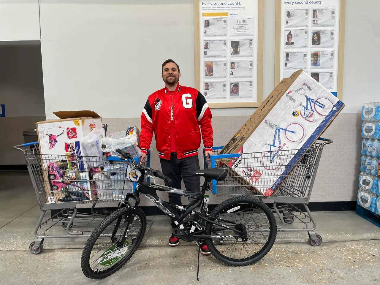 Mason loading carts with toys and bikes for Bay County kids