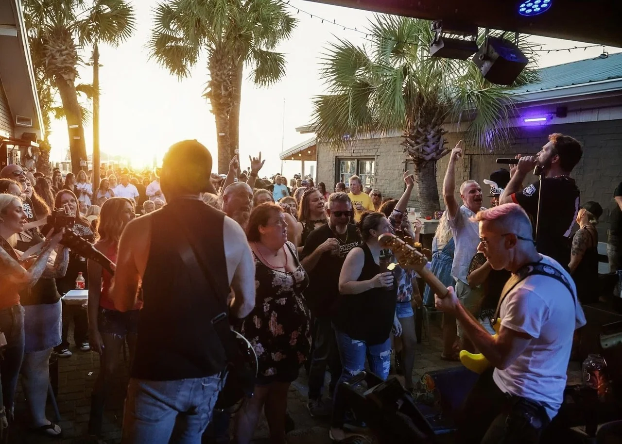 Packed outdoor crowd at Sons of Saints show, Panama City Beach at sunset