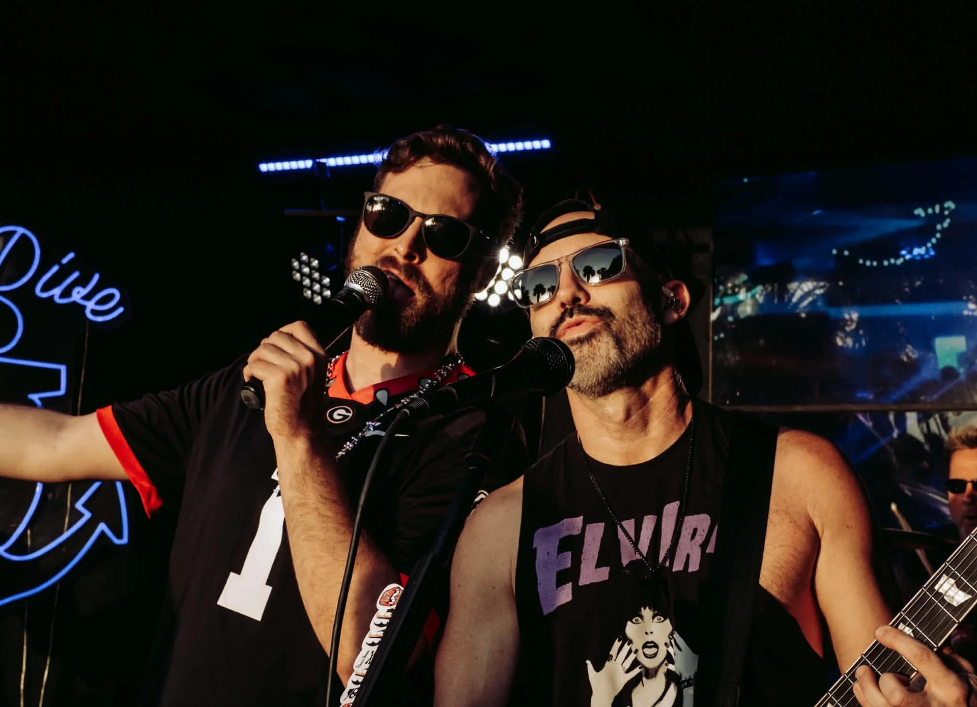 Vocalist and guitarist sharing mic